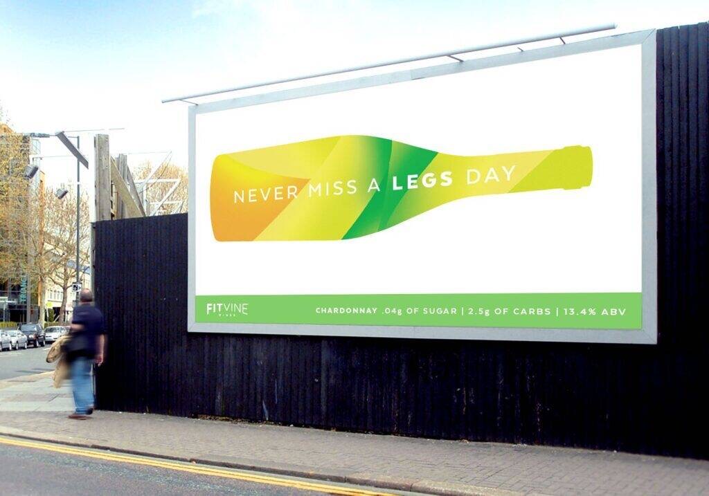 Out-of-home billboard featuring a bottle-shaped graphic with the headline “Never Miss a Legs Day,” highlighting low-sugar Chardonnay positioning created by Agency Squid.