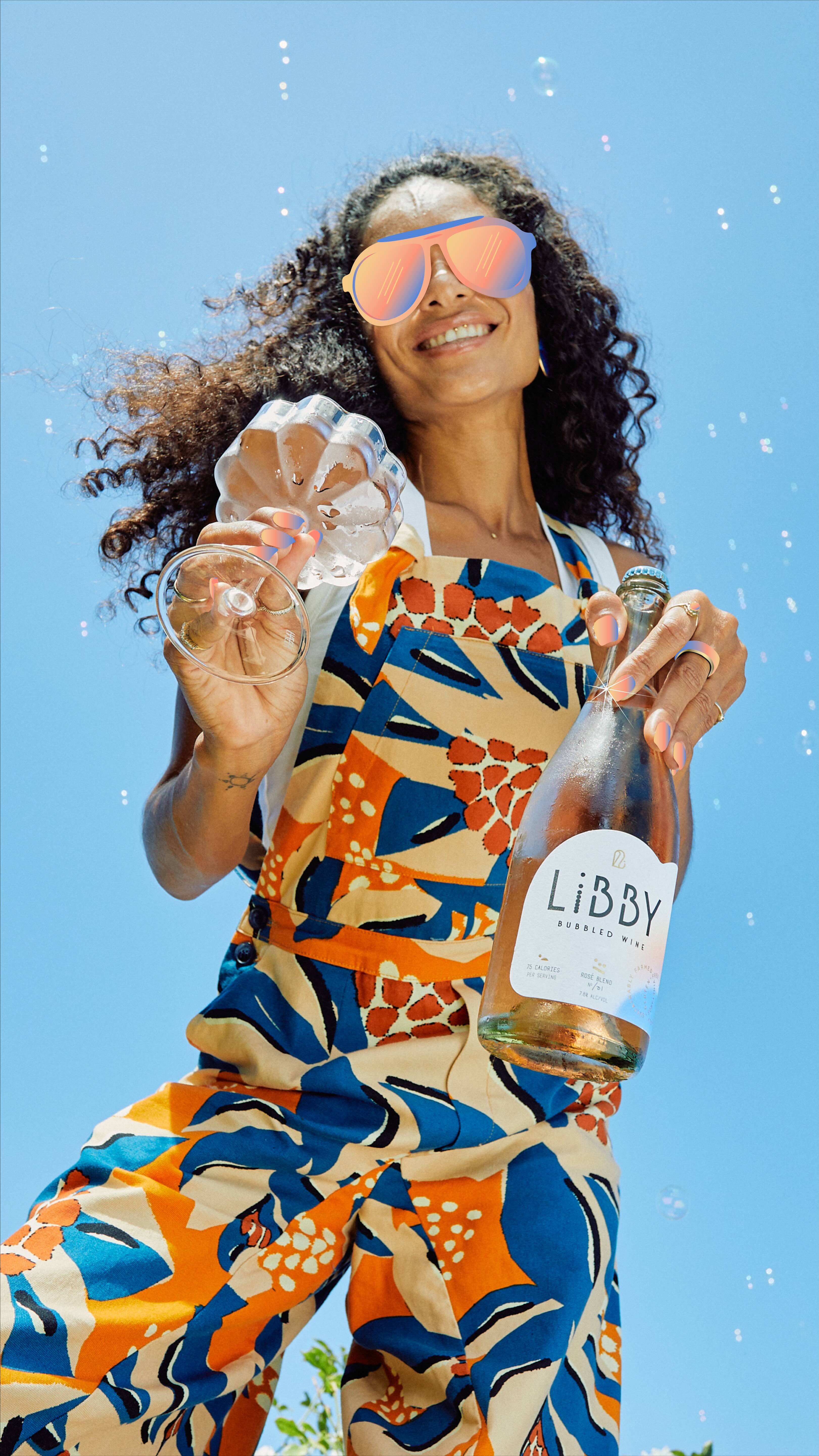 Person enjoying Libby non-alcoholic sparkling wine outdoors, reflecting modern lifestyle branding by Agency Squid